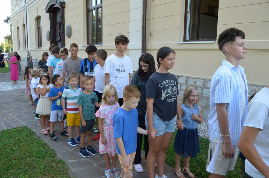 Slika 5: Učenci prvega razreda na poti v šolo v spremstvu starejših učenk in učencev